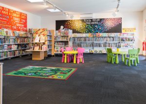 Interior image of childrens section of Doveton Library showing colourful furniture and shelving with books