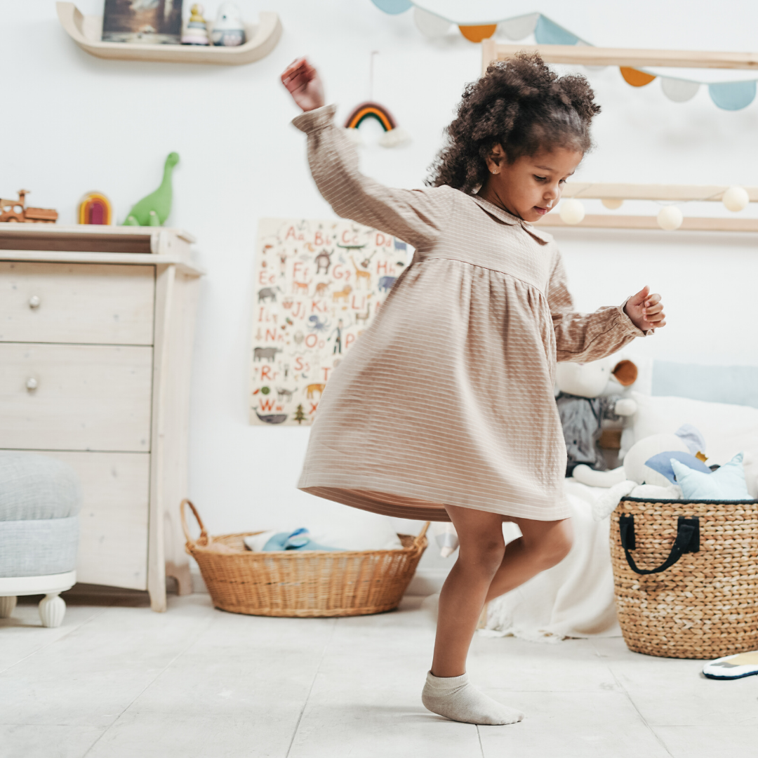 Small girl dancing at home