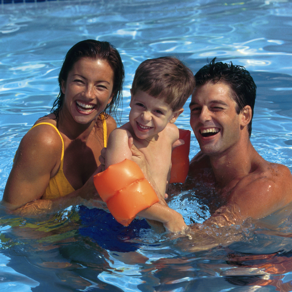 Swimming5 Family of mum, dad and small boy all smiling and swimming