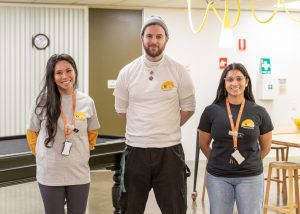 Three staff members at Boroondara Youth Hub. Two female and one male. All wearing t-shirts with Boroondara Youth Hub logo and jeans