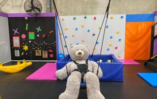 Giant whit teddy in swing at My Puzzle House
