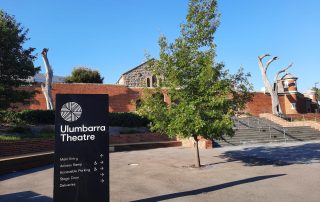 Street view toward main entrance to Ulumbarra Theatre showing signage, steps and theatre building