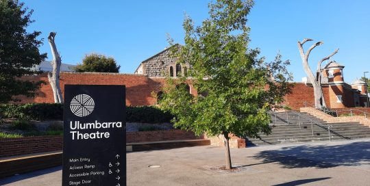 Street view toward main entrance to Ulumbarra Theatre showing signage, steps and theatre building