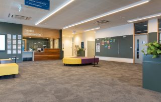 Interior of Kirrip Community Centre with carpeted floor, furniture and information desk