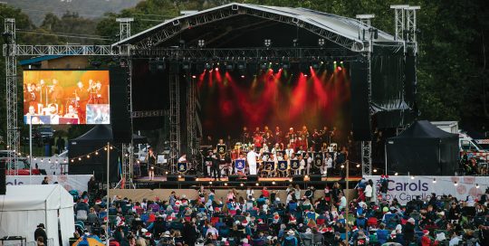 Knox Carols by Candlelight event showing stage, performers and patrons in crowd