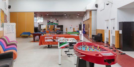 Melton Youth Centre Recreation Area with pool table, fusball table and furniture around the outside of room
