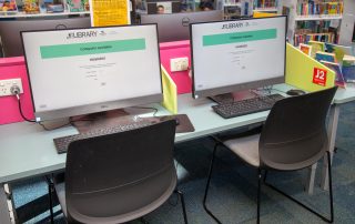 Two desktop computers on a desk at Hastings Library