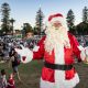 Town of Cambridge Carols by the Lake event with Santa in the foreground and event attendees in the background