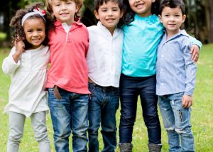 A group of five children standing in a row