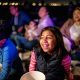 Children seated outdoors with popcorn watching a movie